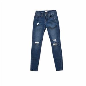 Sneak peek woman’s dark wash denim skinny jeans with wholes and distressing
